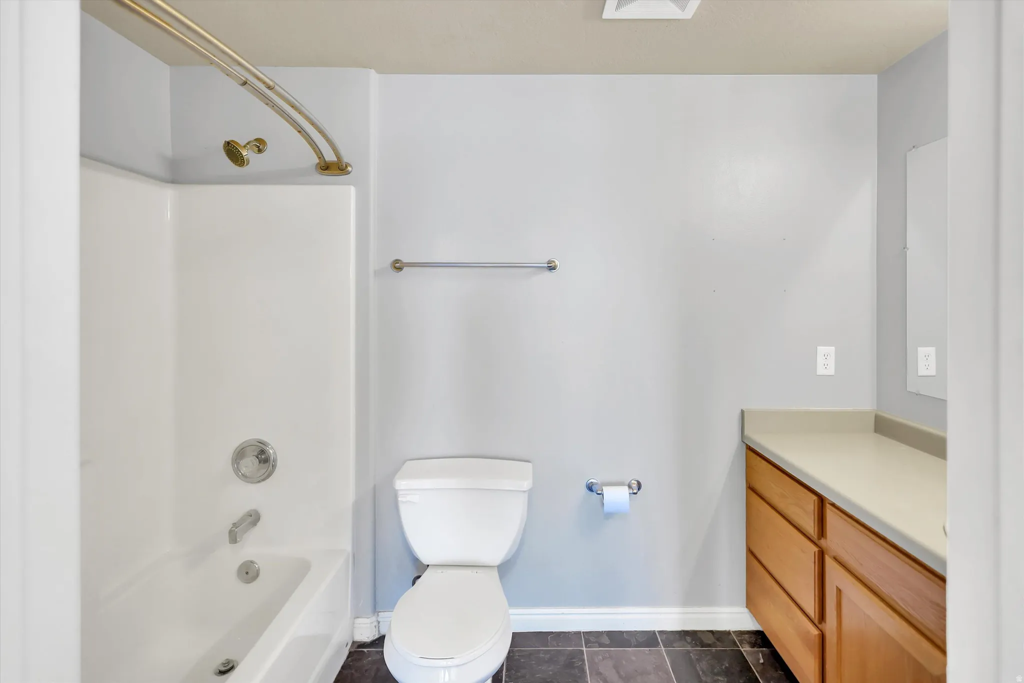 Full bath featuring vanity and shower / bath combination