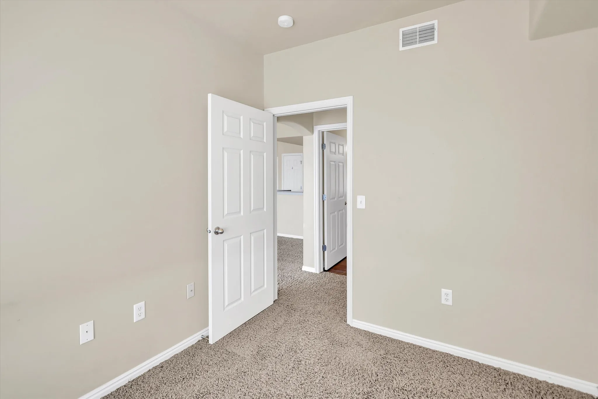 Empty room with baseboards and light carpet