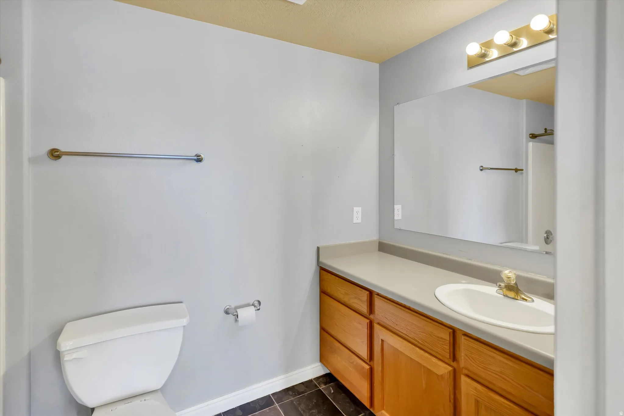 Bathroom featuring vanity and toilet