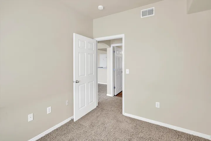 Empty room with baseboards and light carpet