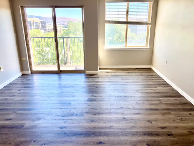 Expansive wood-finish flooring throughout