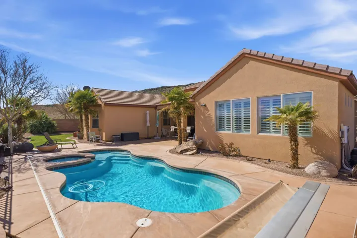 Combined pool / hot tub featuring a patio area