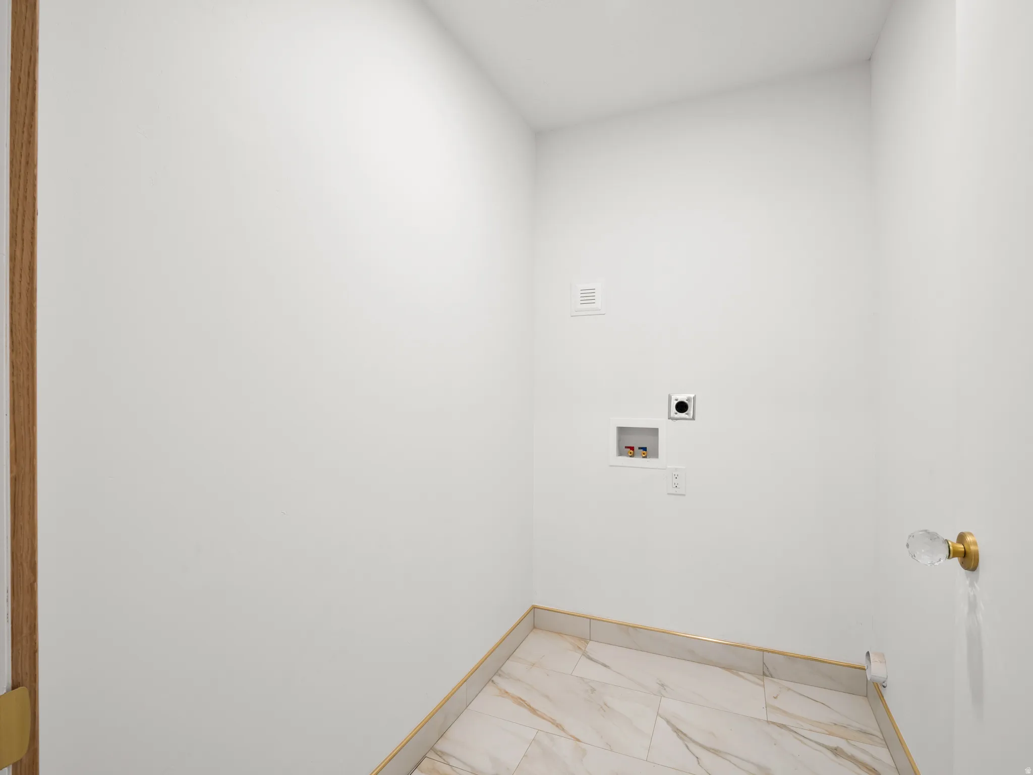 Laundry room featuring light marble finish floors, hookup for an electric dryer, and hookup for a washing machine