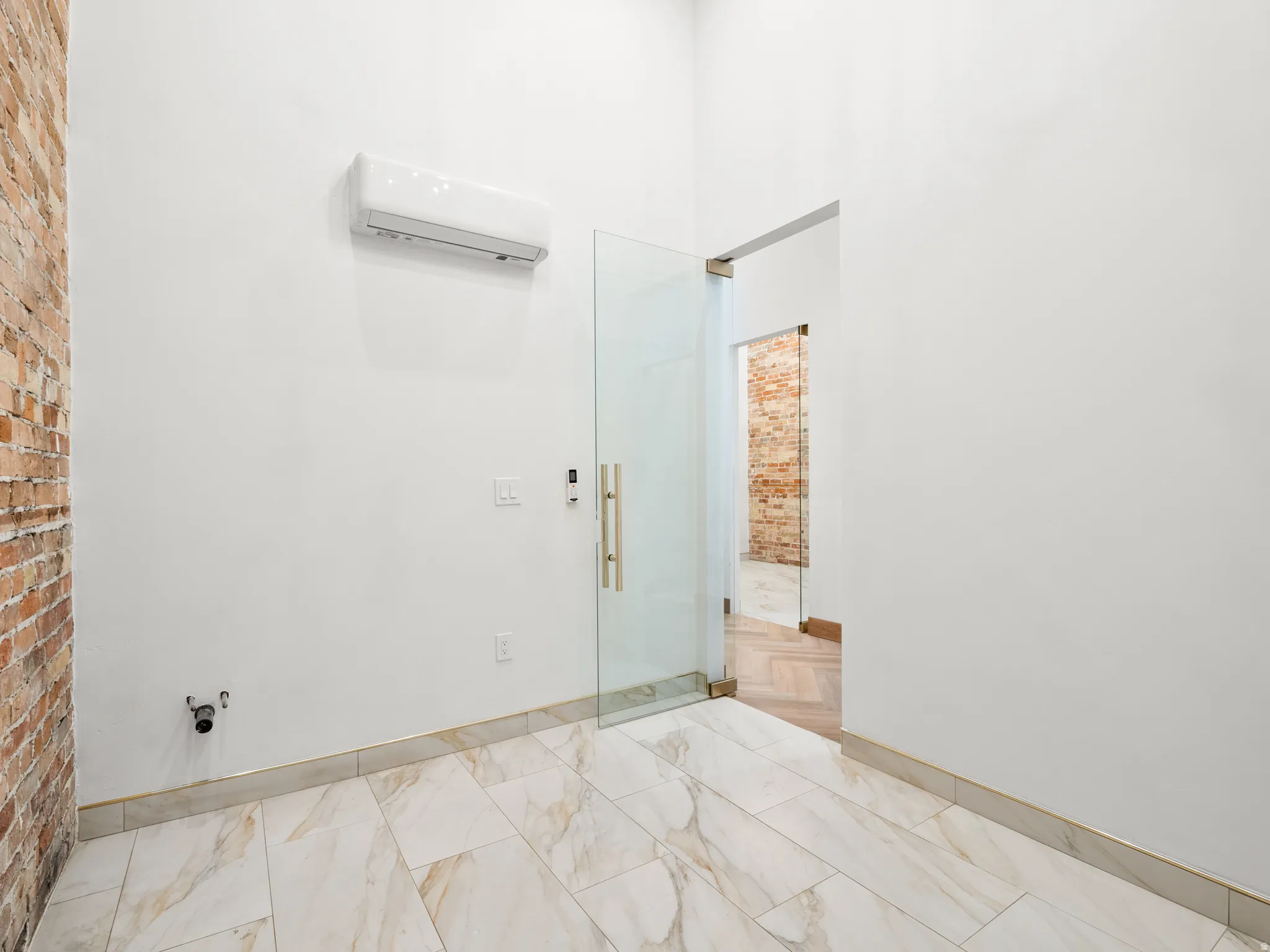 Bathroom featuring a wall mounted mini split and a shower stall