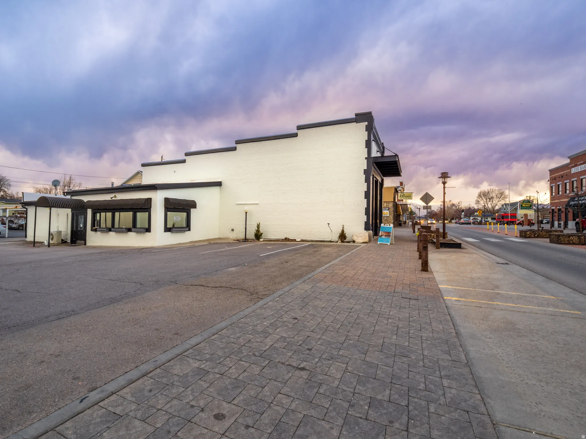 View of commercial location featuring uncovered parking