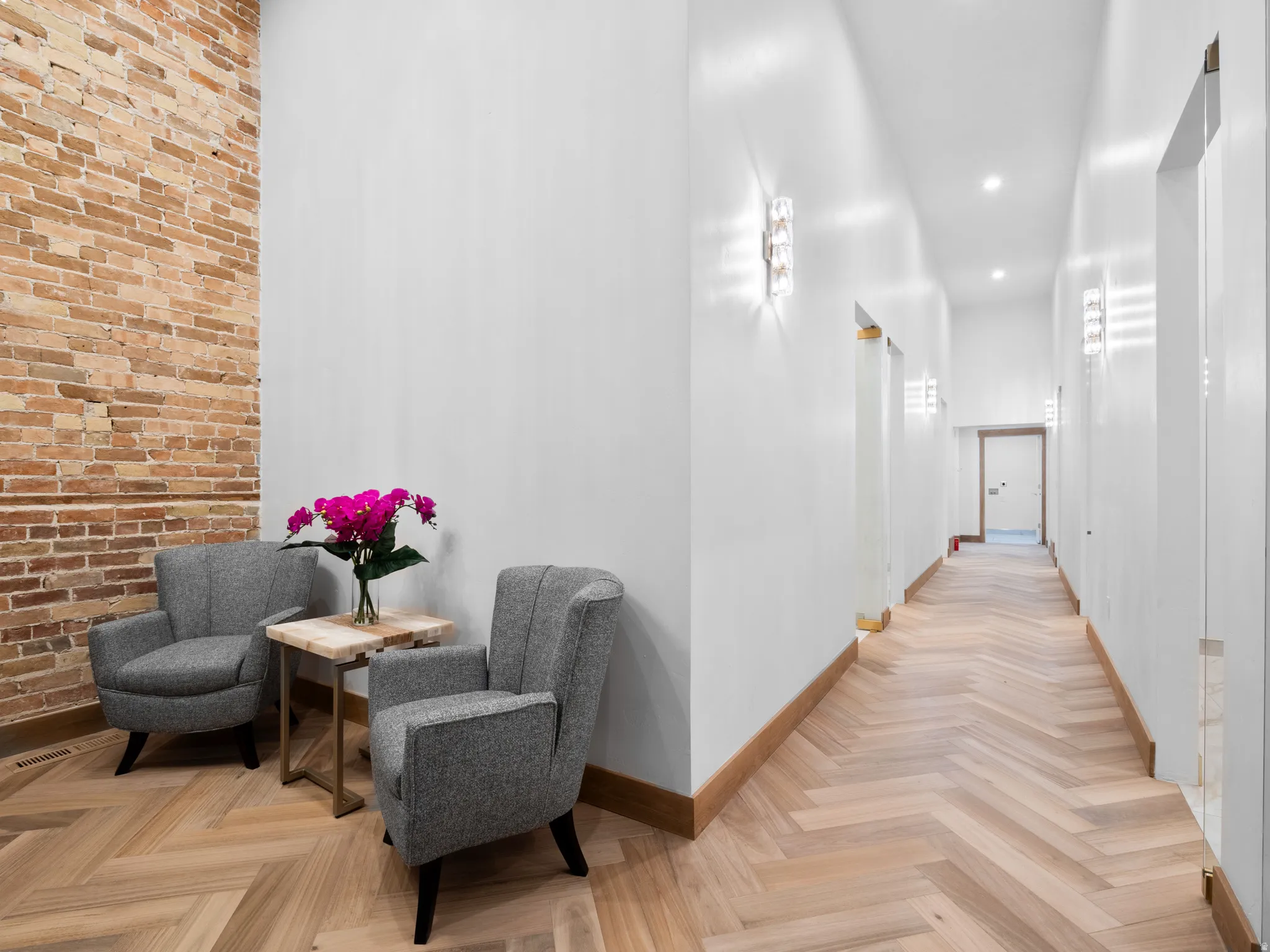 Hallway featuring parquet flooring and baseboards