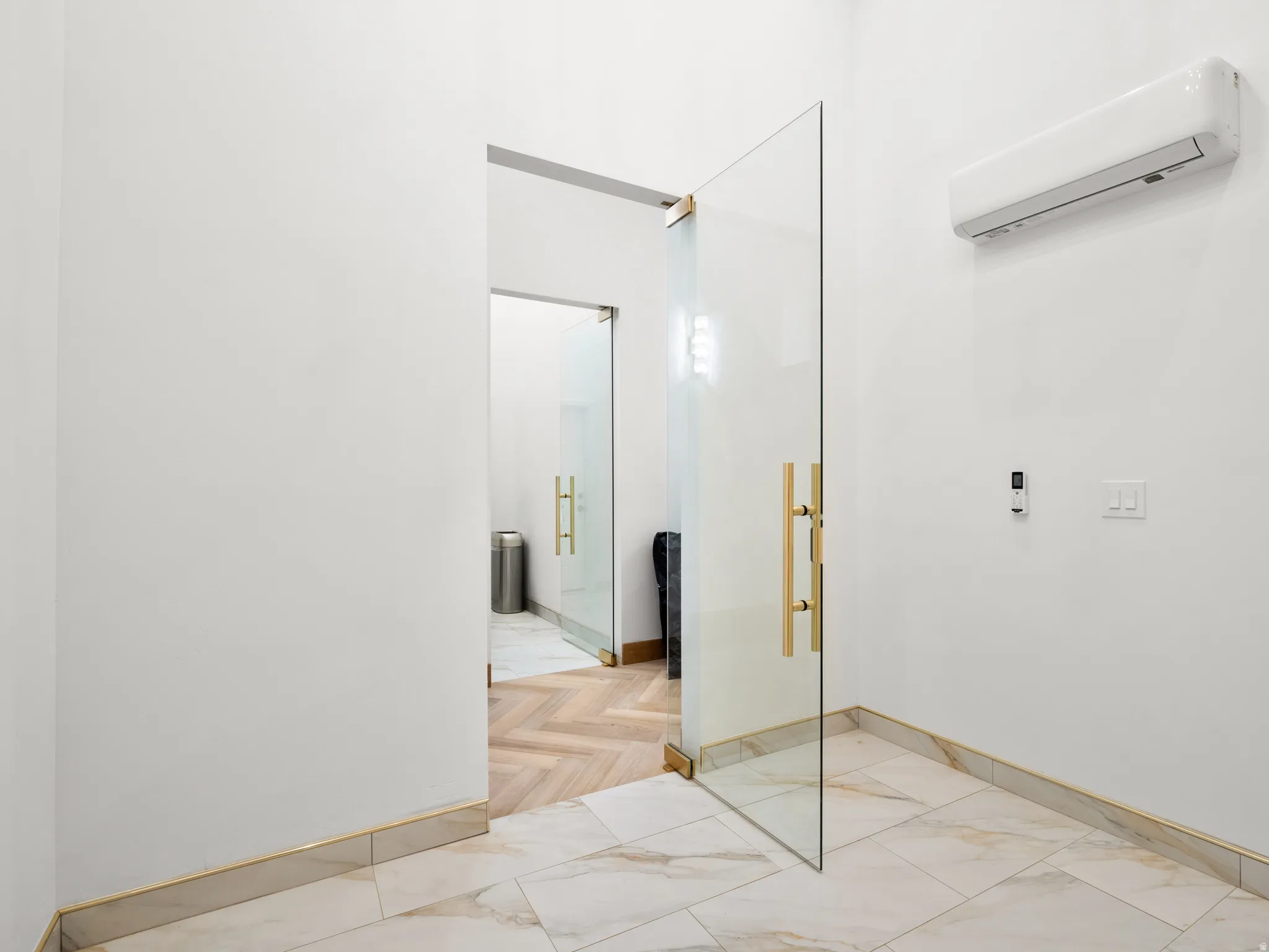 Empty room with a wall mounted mini split and baseboards