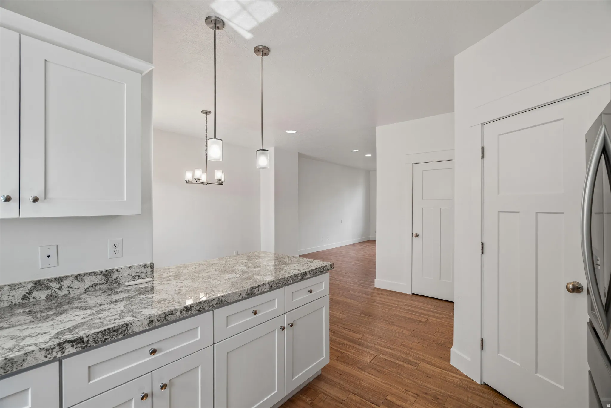 Kitchen featuring white cabinetry and light-colored countertops with a subtle pattern