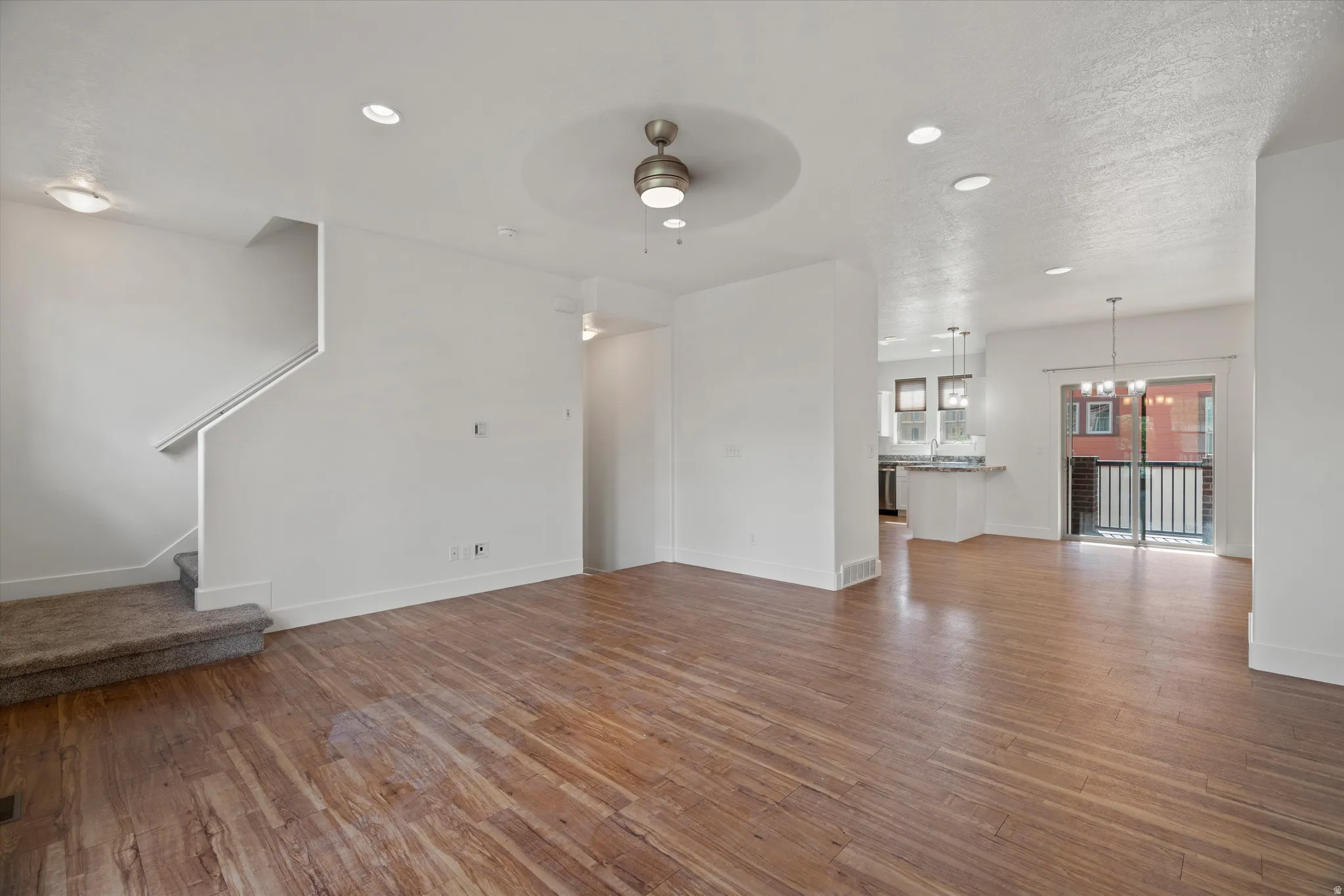 Spacious living area featuring wood-finish flooring and recessed lighting