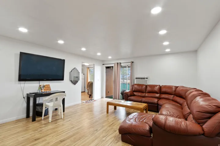 Living room with light wood finished floors and recessed lighting