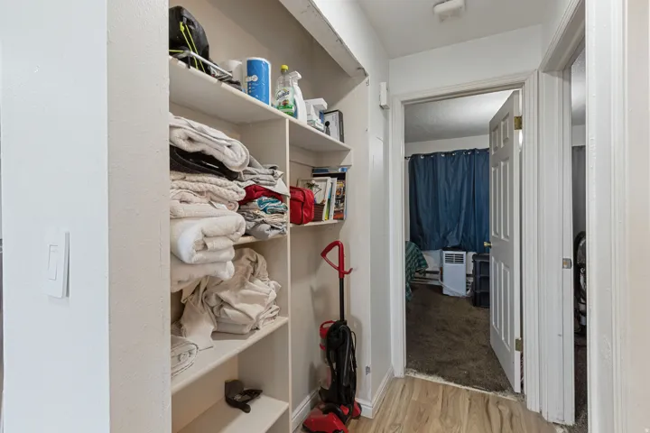 Walk in closet with light wood-style flooring