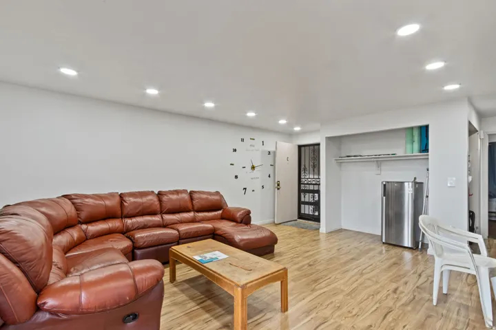 Living room with light wood-style floors and recessed lighting