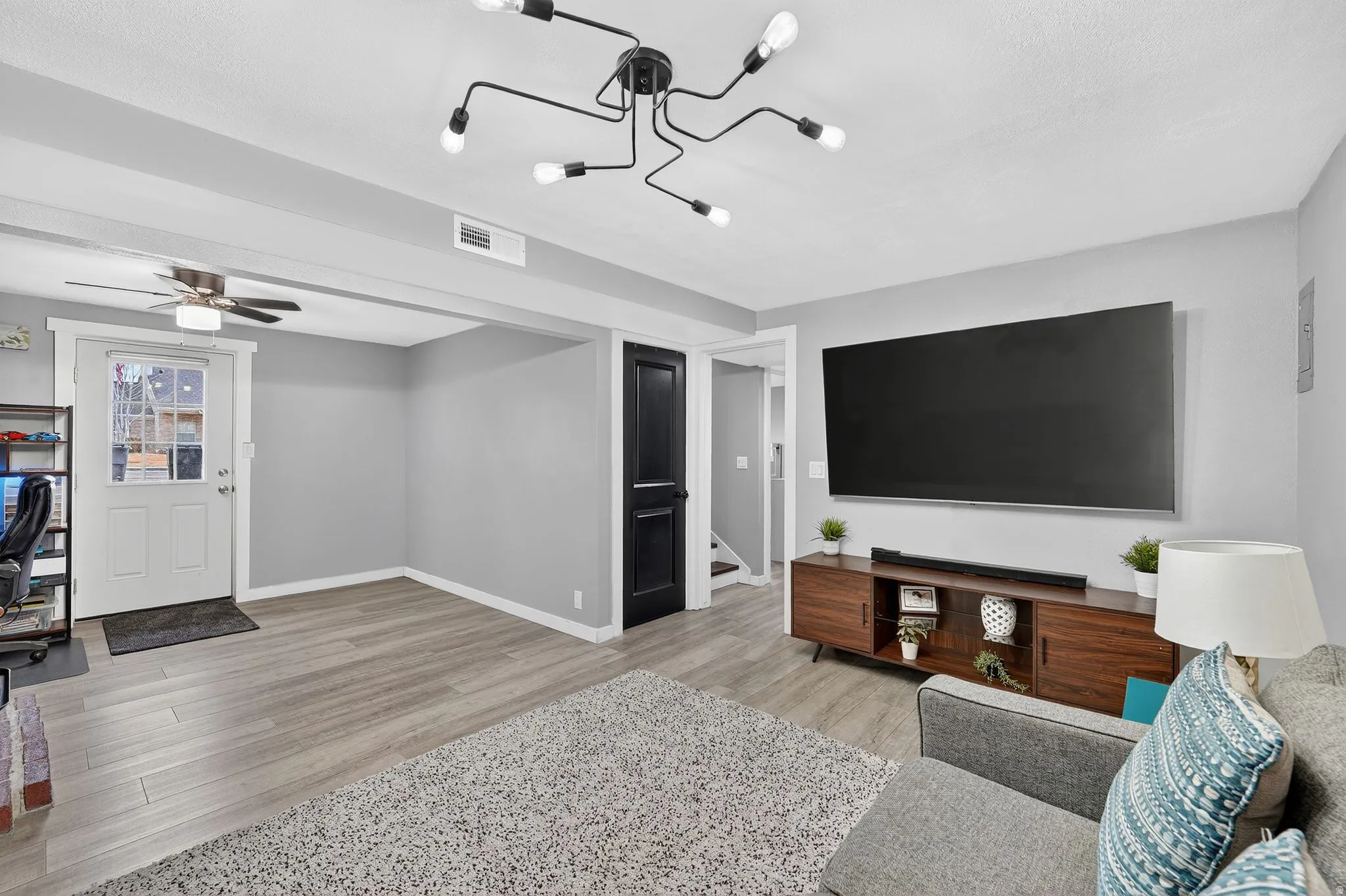 Living area featuring a ceiling fan and light wood-type flooring
