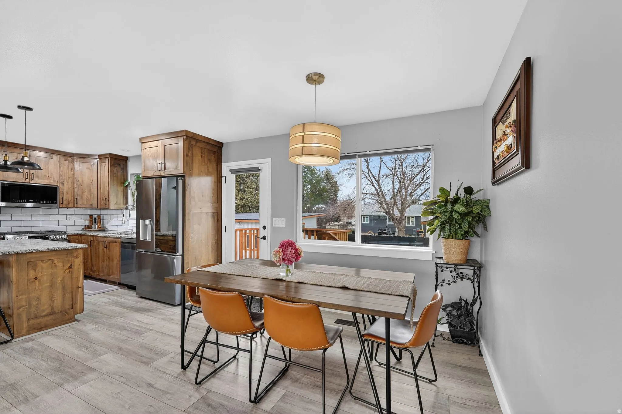 Dining area with light wood-style flooring and baseboards