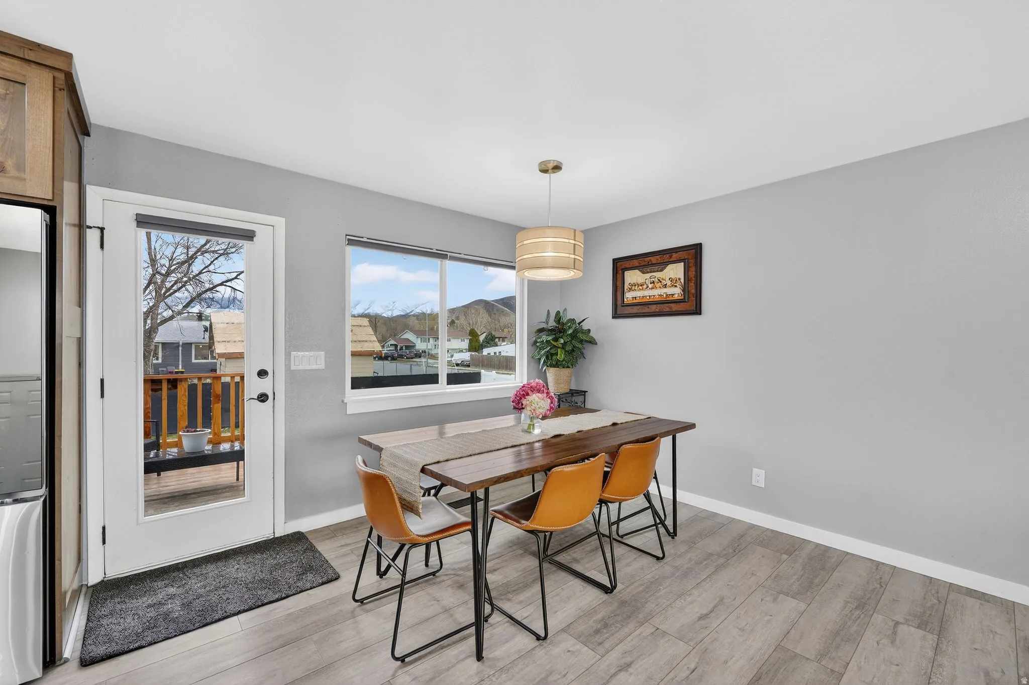 Dining area with light wood finished floors and baseboards