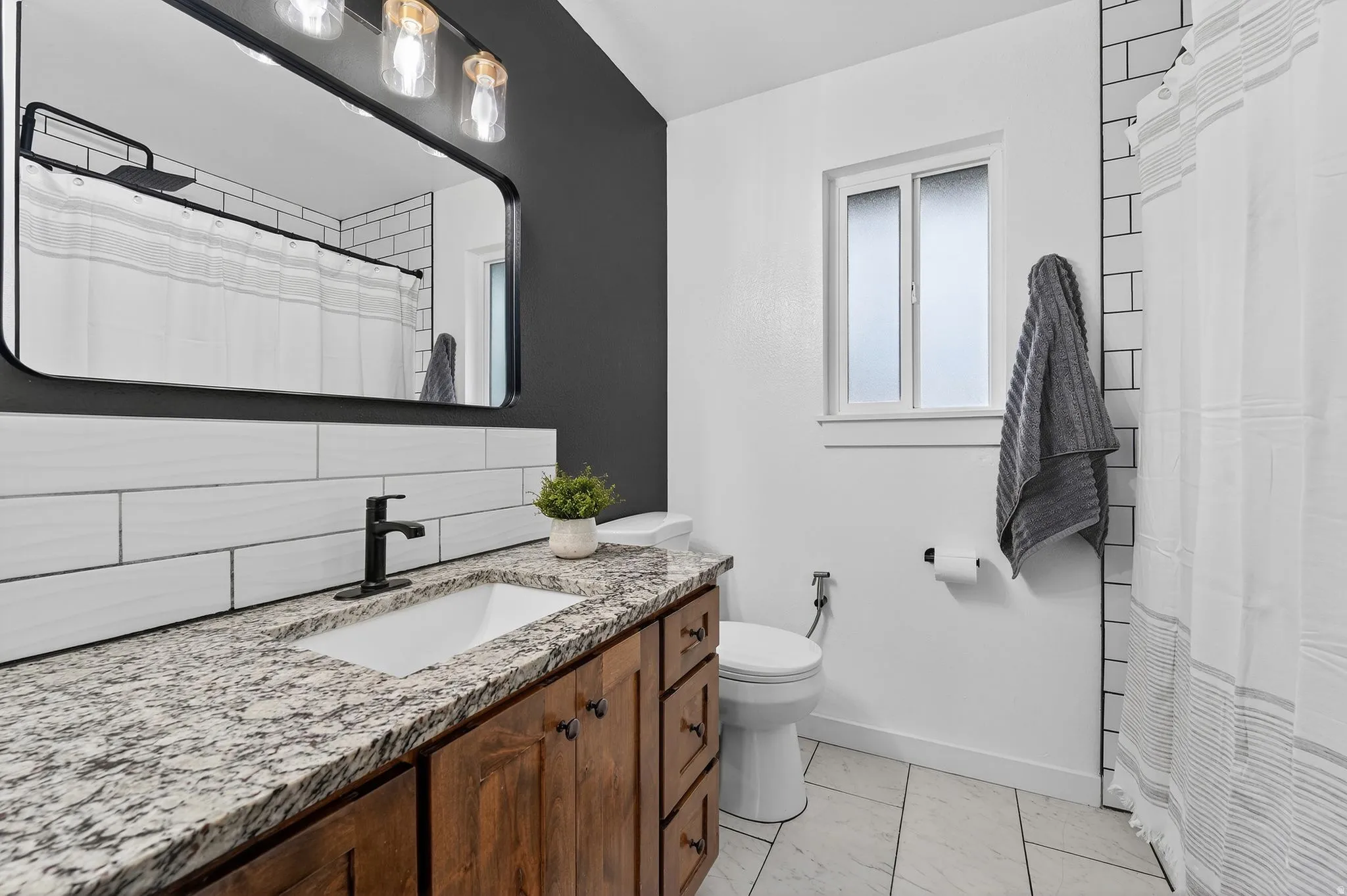 Full bath featuring vanity and a shower with shower curtain