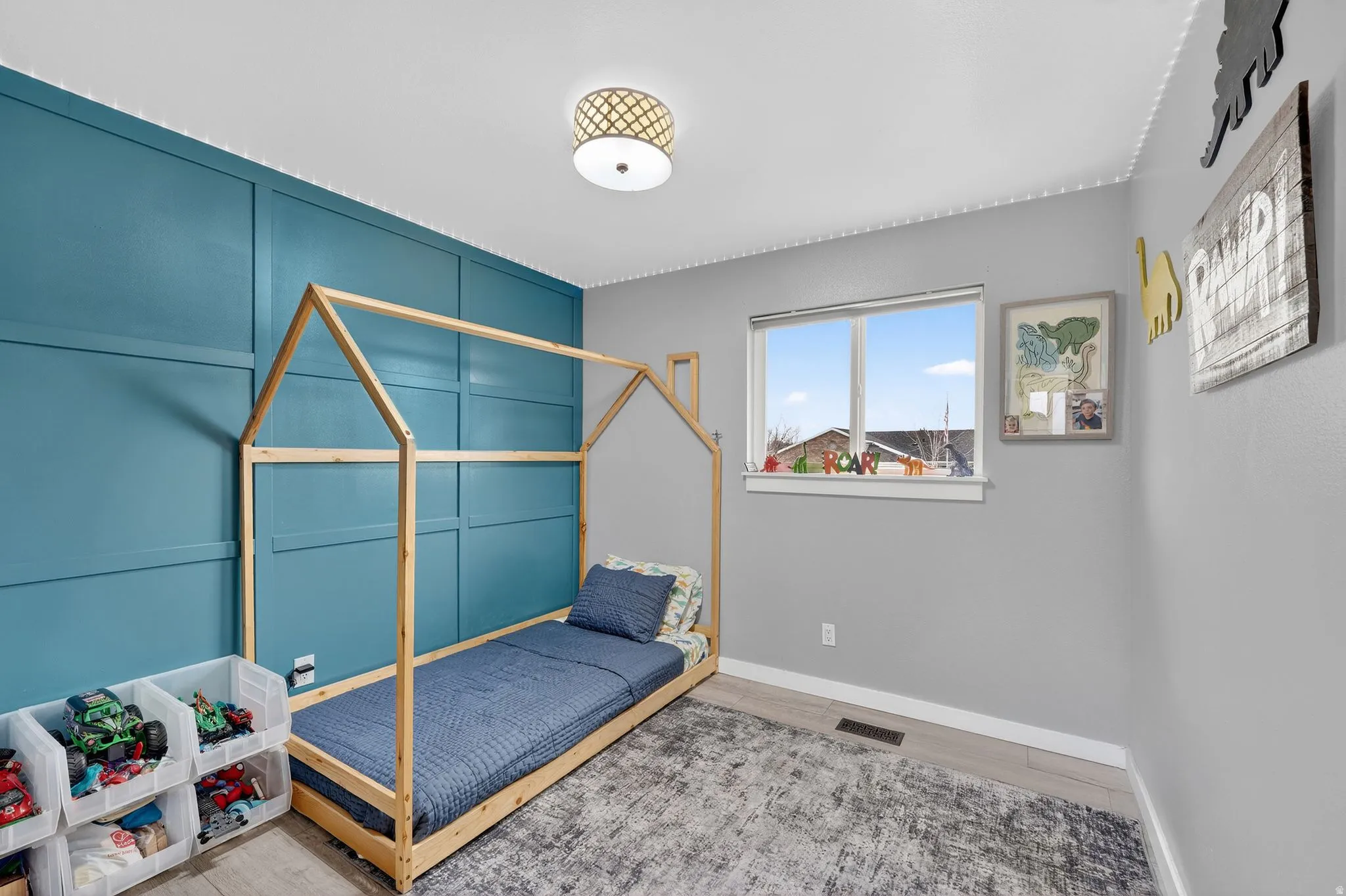 Bedroom with baseboards and light wood-type flooring