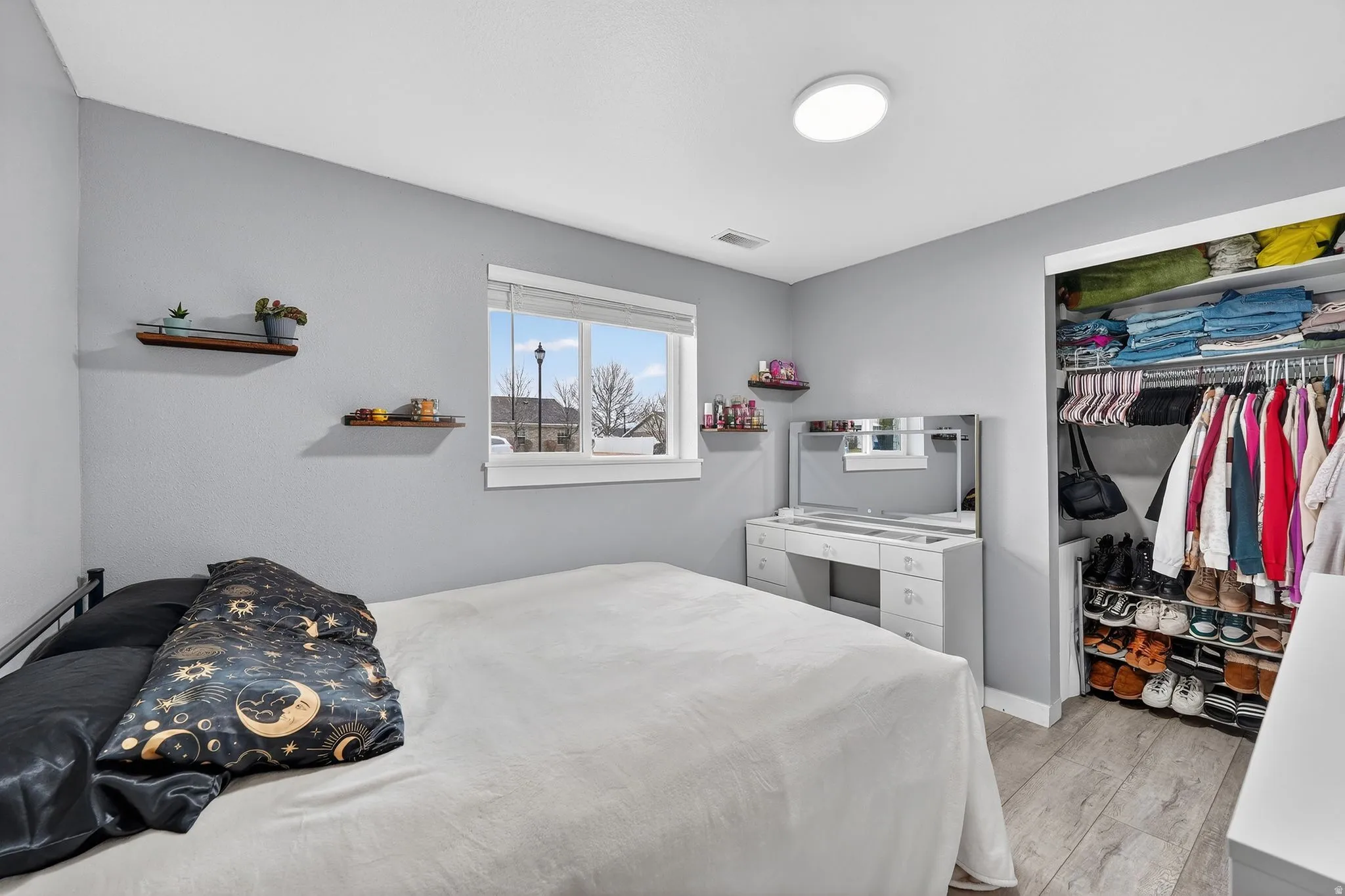 Bedroom featuring light wood-style flooring and a closet