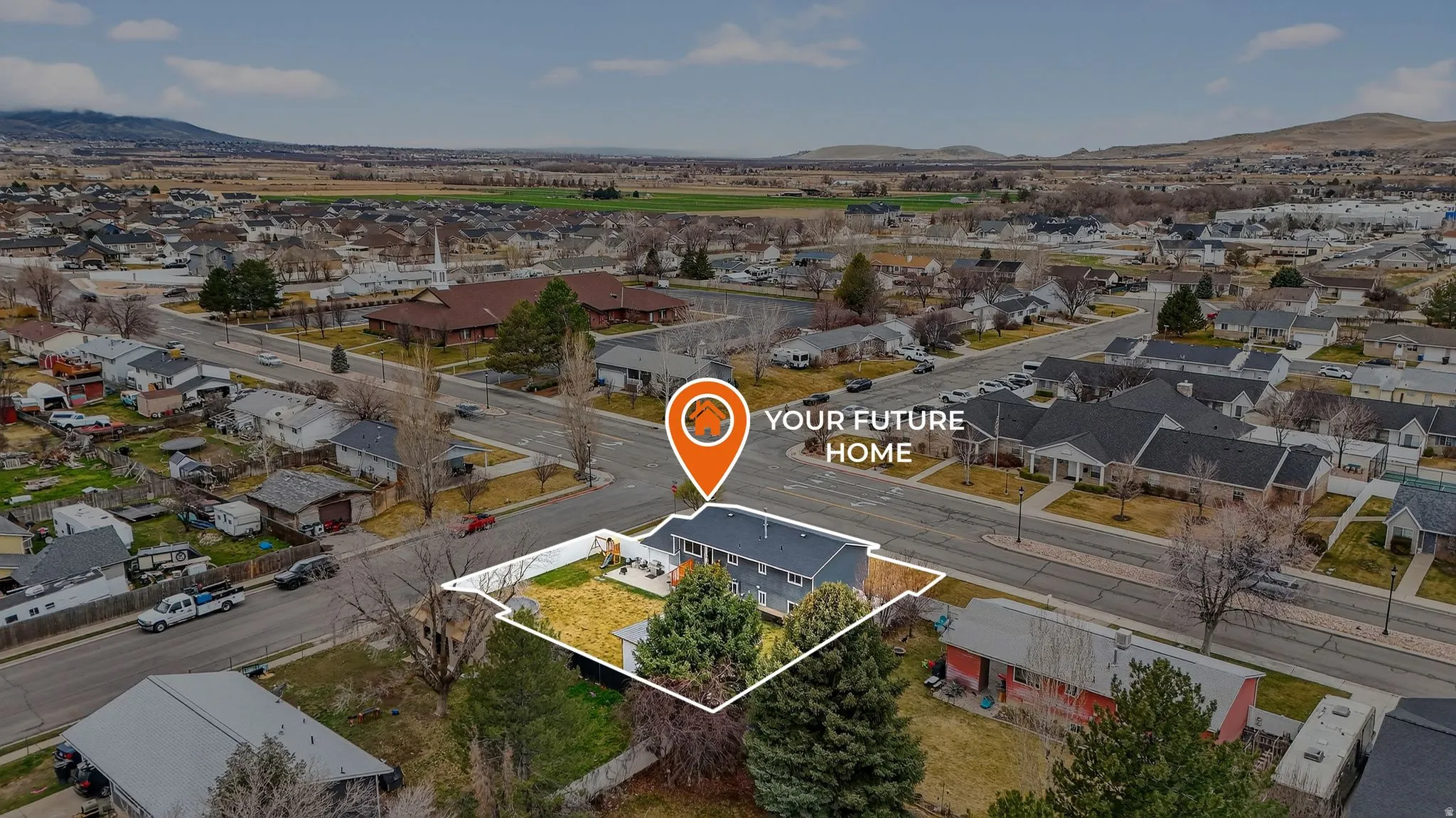 Aerial perspective of suburban area featuring a mountainous background