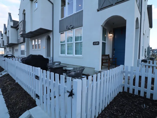 View of home's exterior featuring a gate, stucco siding, and a fenced front yard
