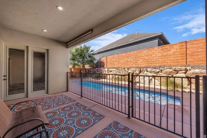 Patio / terrace featuring a fenced backyard, a patio area, and a hot tub