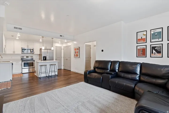 Living area featuring dark wood-type flooring and baseboards