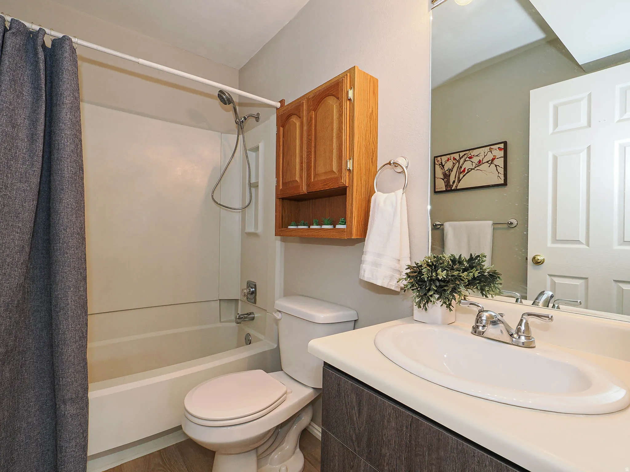 Full bathroom featuring vanity and shower / bathtub combination with curtain
