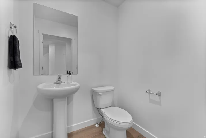 Bathroom featuring toilet and light wood-style floors