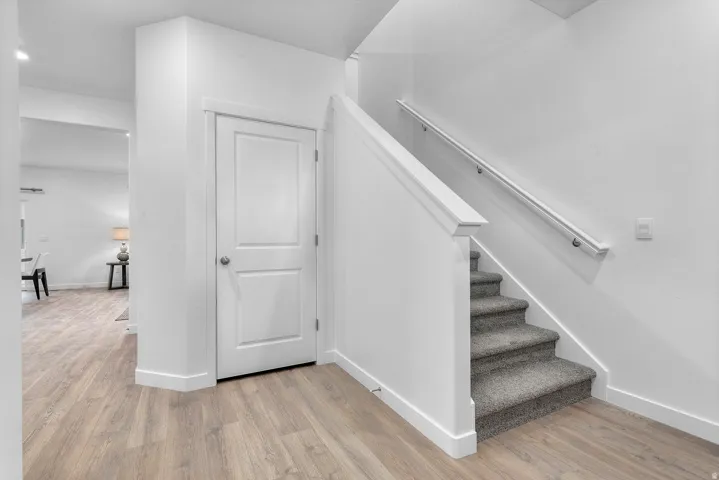 Staircase featuring wood finished floors