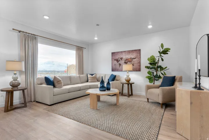 Living room with light wood-type flooring, recessed lighting, and a mountain view