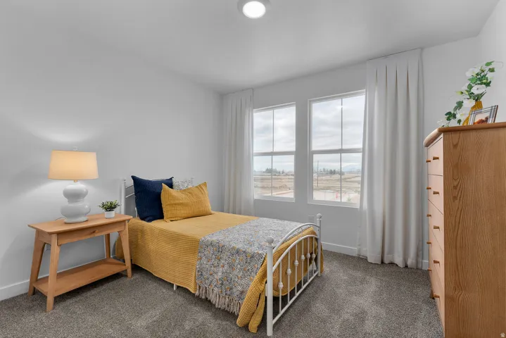 Carpeted bedroom featuring baseboards