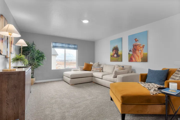 Carpeted living area featuring baseboards