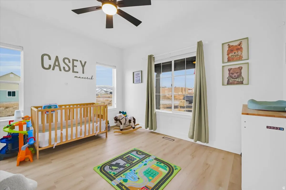 Bedroom with light wood-type flooring and ceiling fan