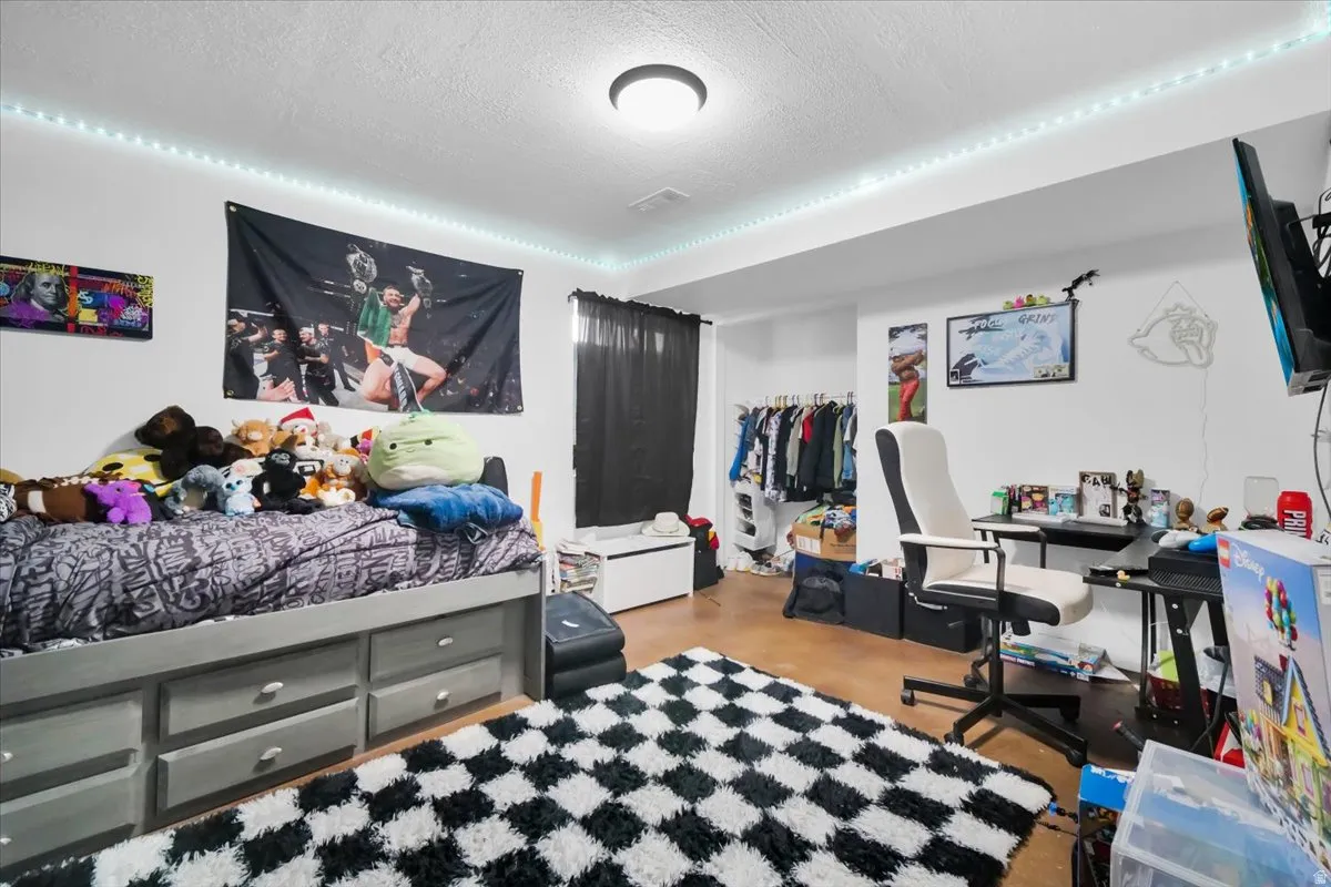 Bedroom featuring a textured ceiling and a closet