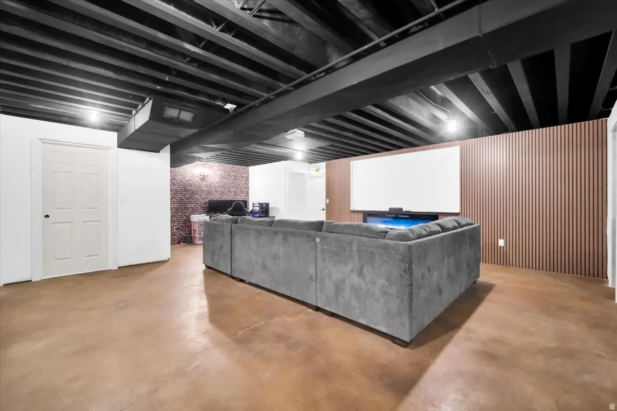 Living area with concrete floors and brick wall