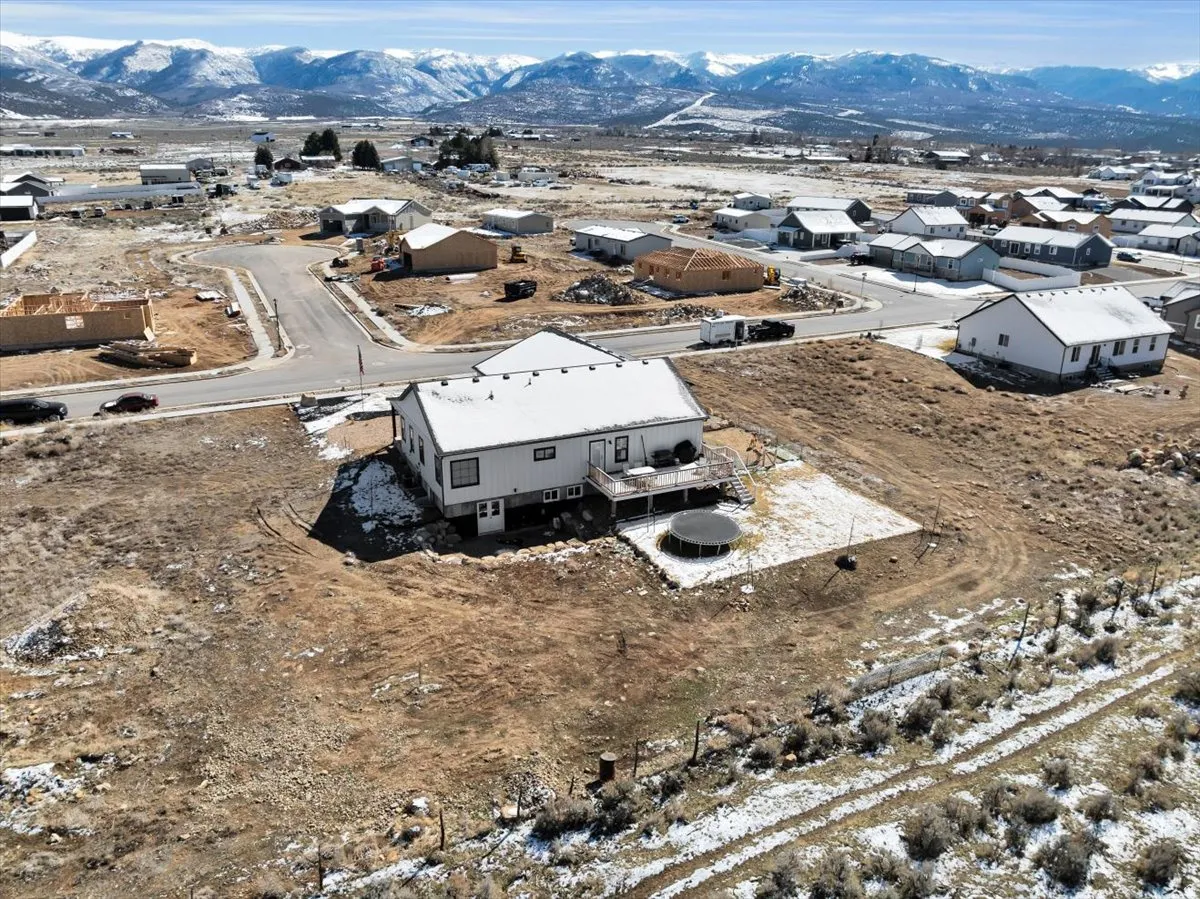Snowy aerial view with a residential view and a mountain view