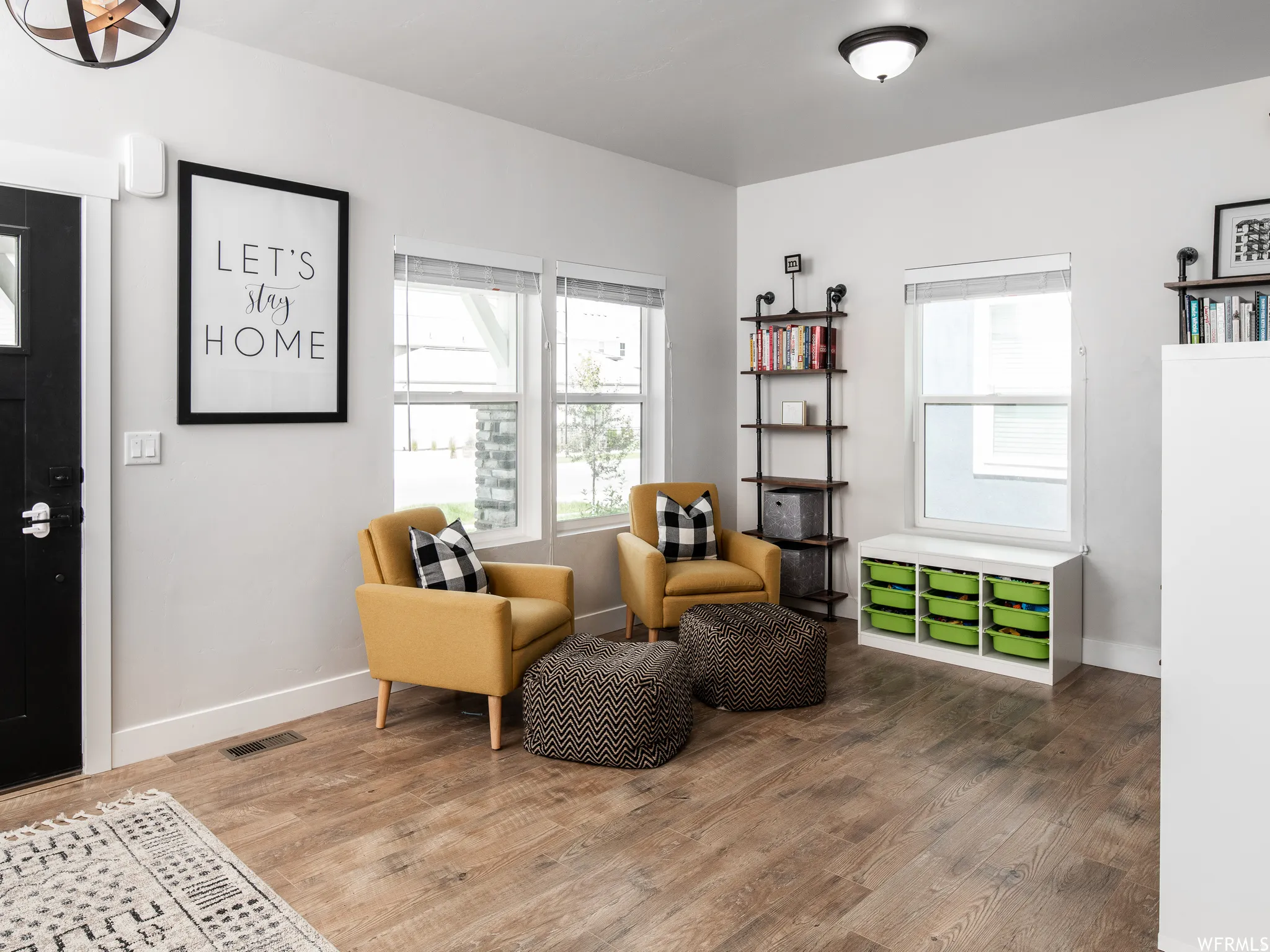 Sitting room with healthy amount of natural light and wood finished floors