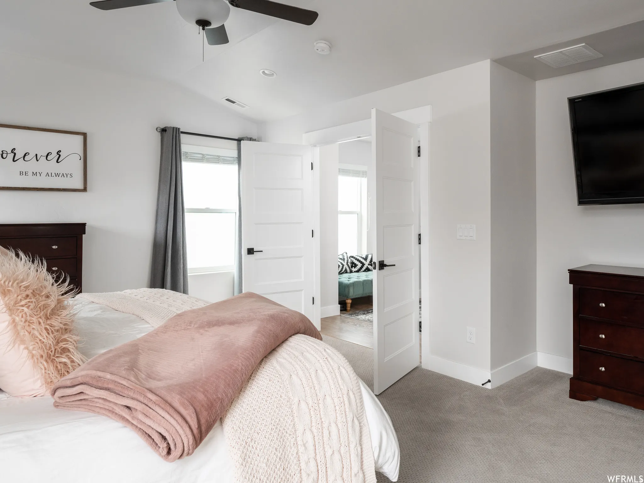 Bedroom featuring light colored carpet, lofted ceiling, a ceiling fan, and recessed lighting