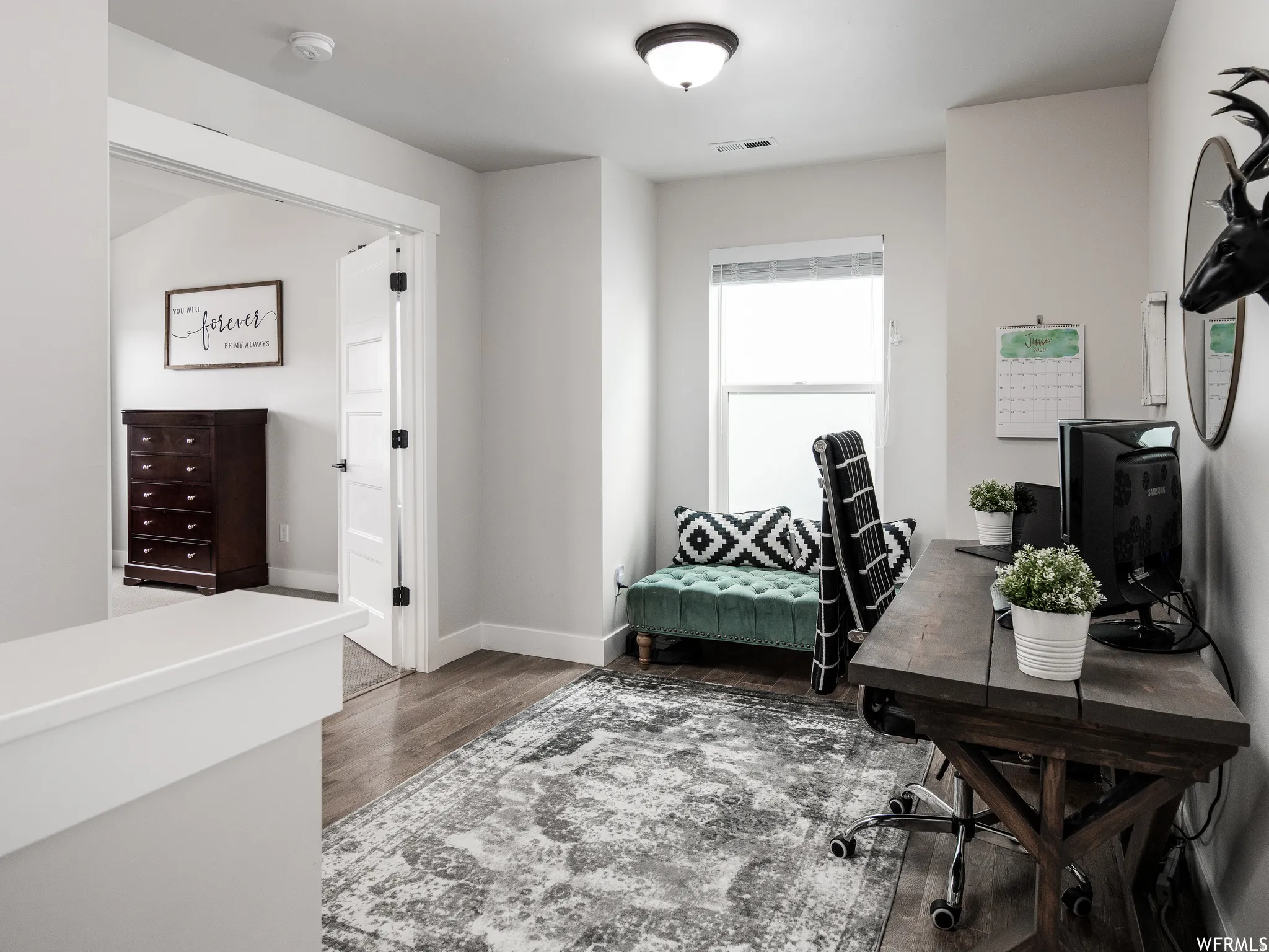 Office featuring dark wood-type flooring and baseboards