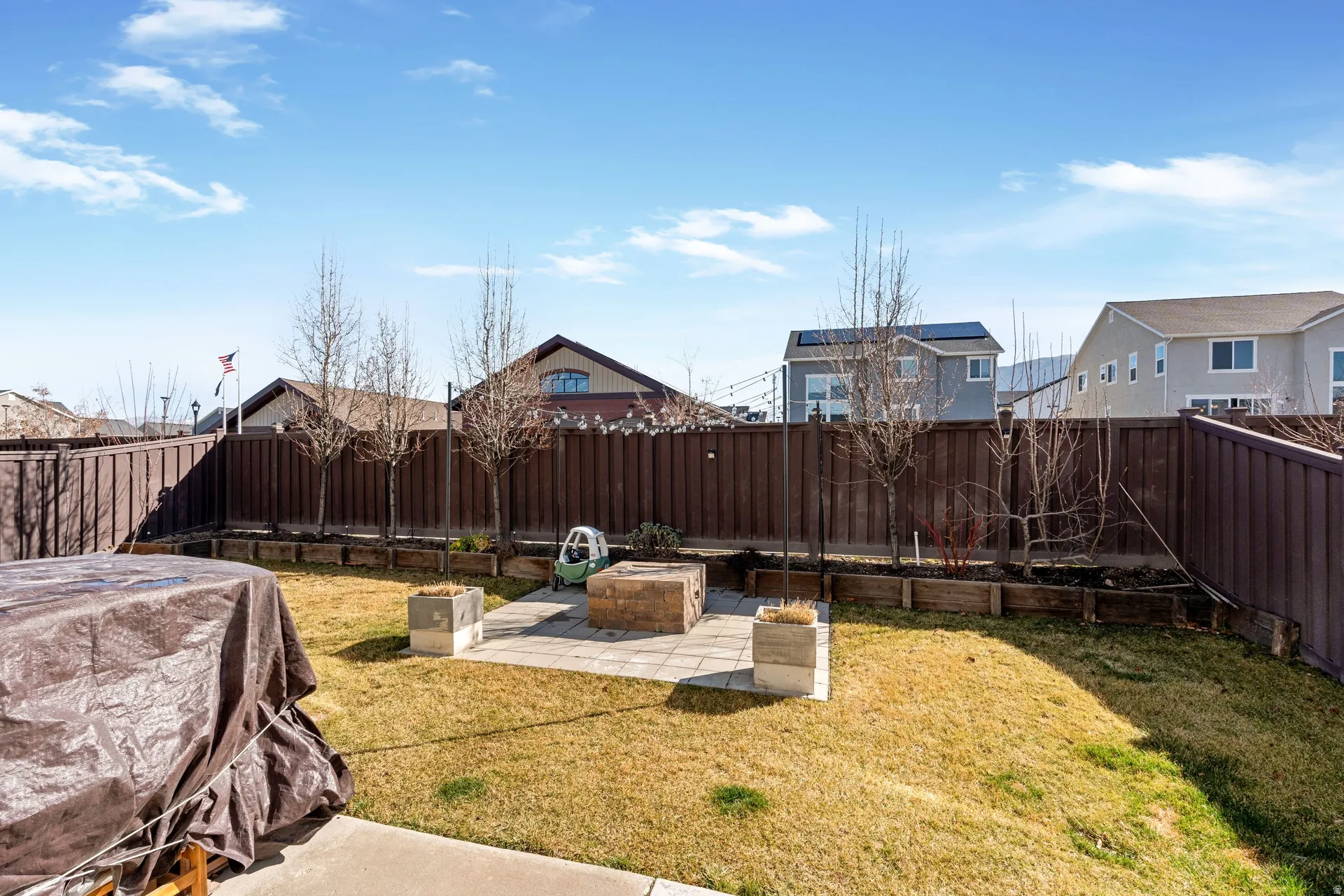 Fenced backyard with a patio and a residential view
