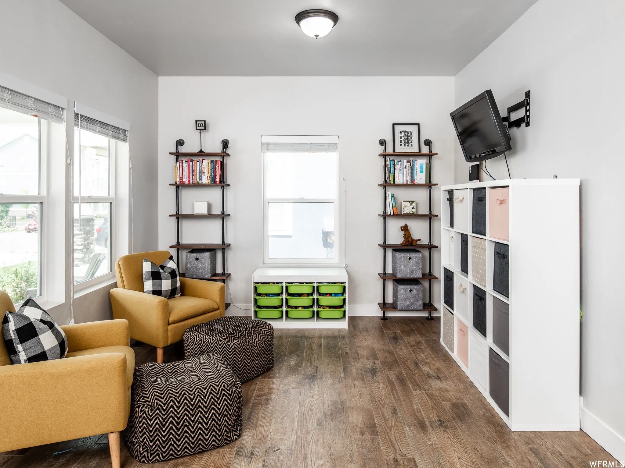 Living area with dark wood-style floors and baseboards