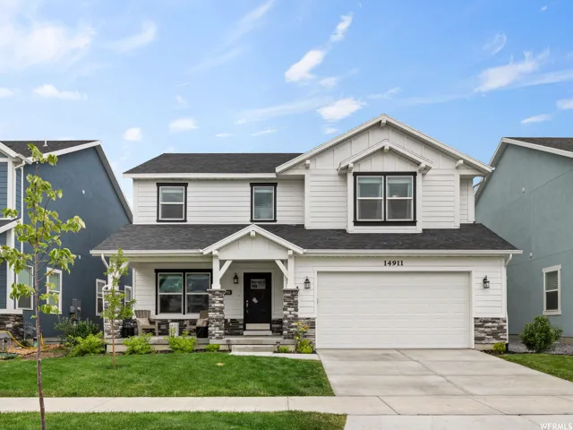 Craftsman house featuring covered porch, stone siding, driveway, board and batten siding, and an attached garage