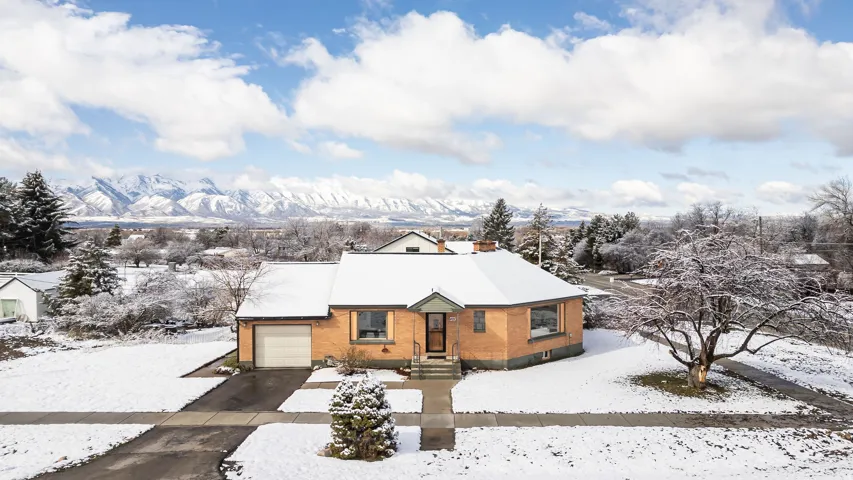 Home with mountain views an attached garage and driveway
