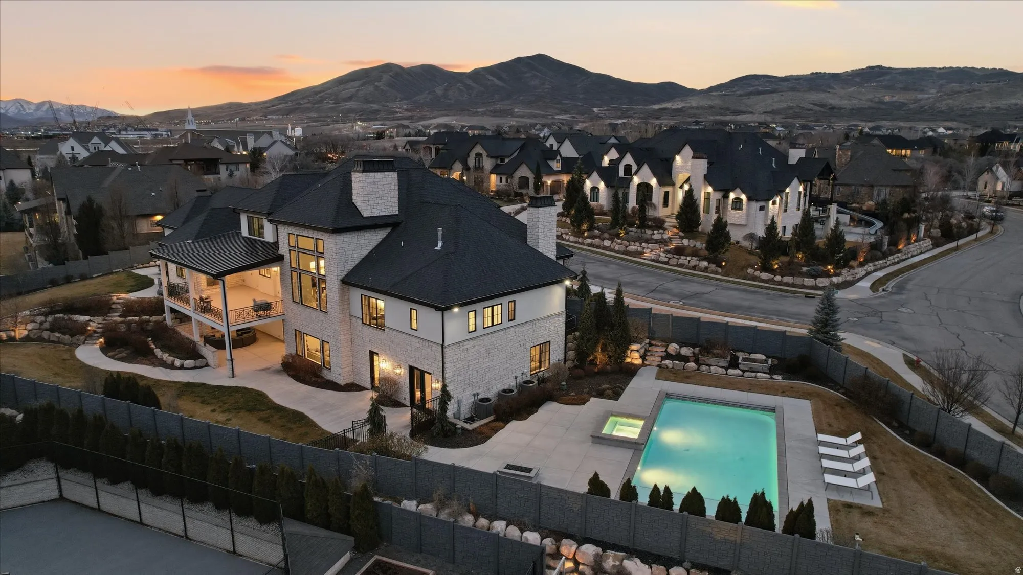 Aerial view at dusk of a mountain view and view of pool