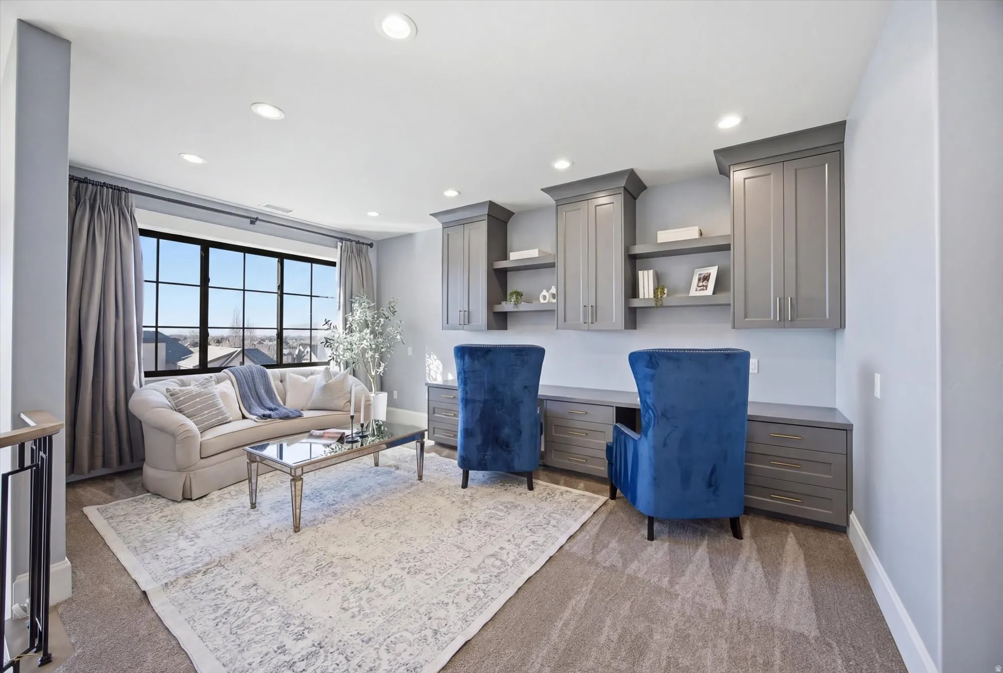 Living room featuring built in study area, light carpet, and recessed lighting