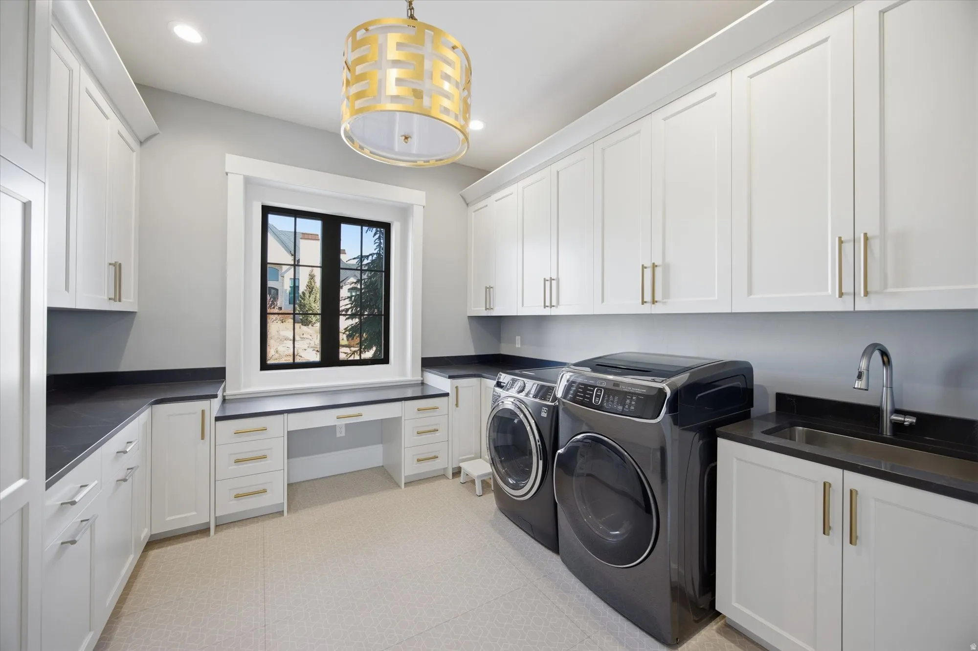 Laundry room with separate washer and dryer, cabinet space, recessed lighting, light flooring, and an office area