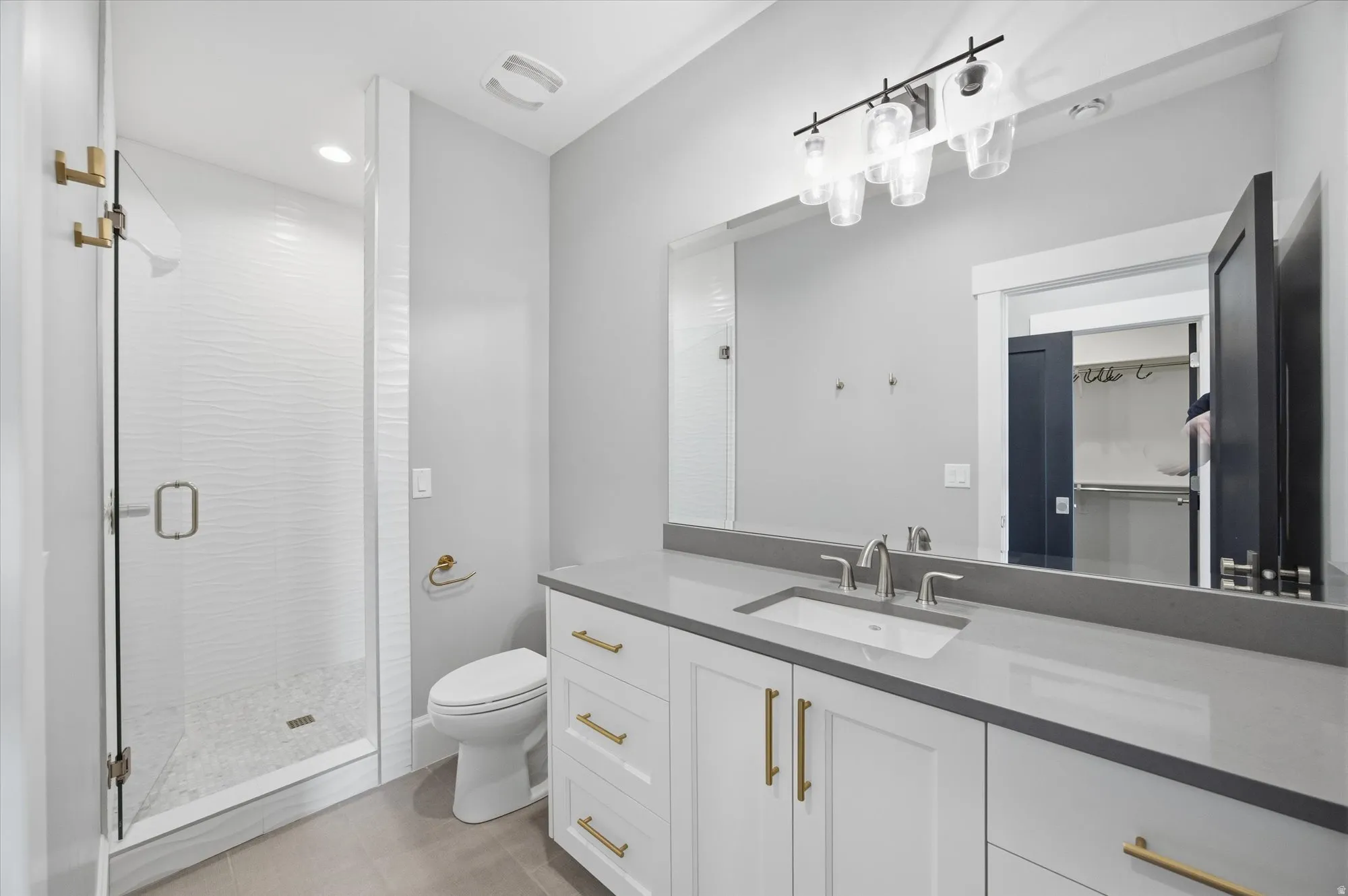 Bathroom with vanity, a stall shower, and recessed lighting