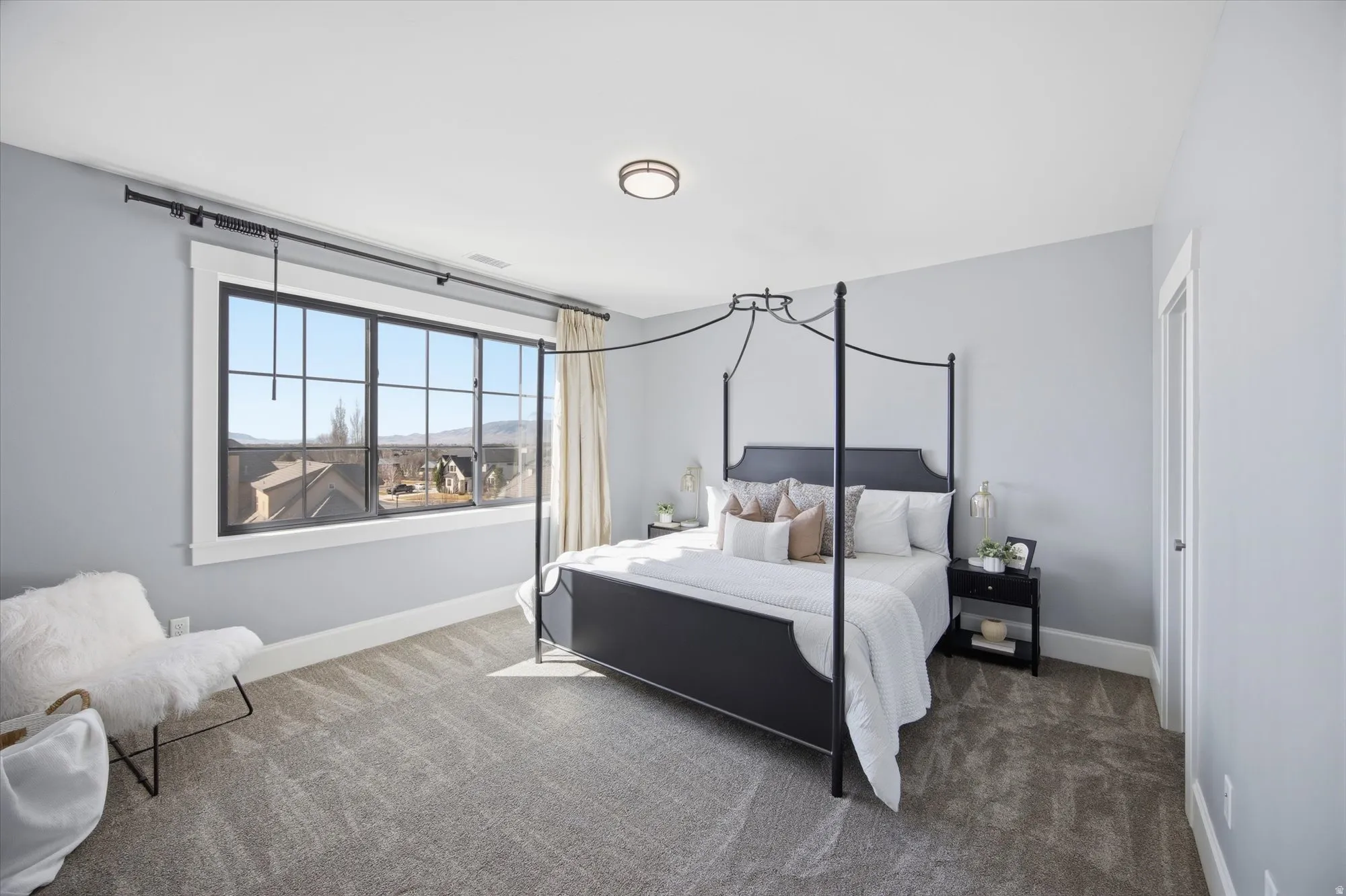 Bedroom featuring carpet and baseboards