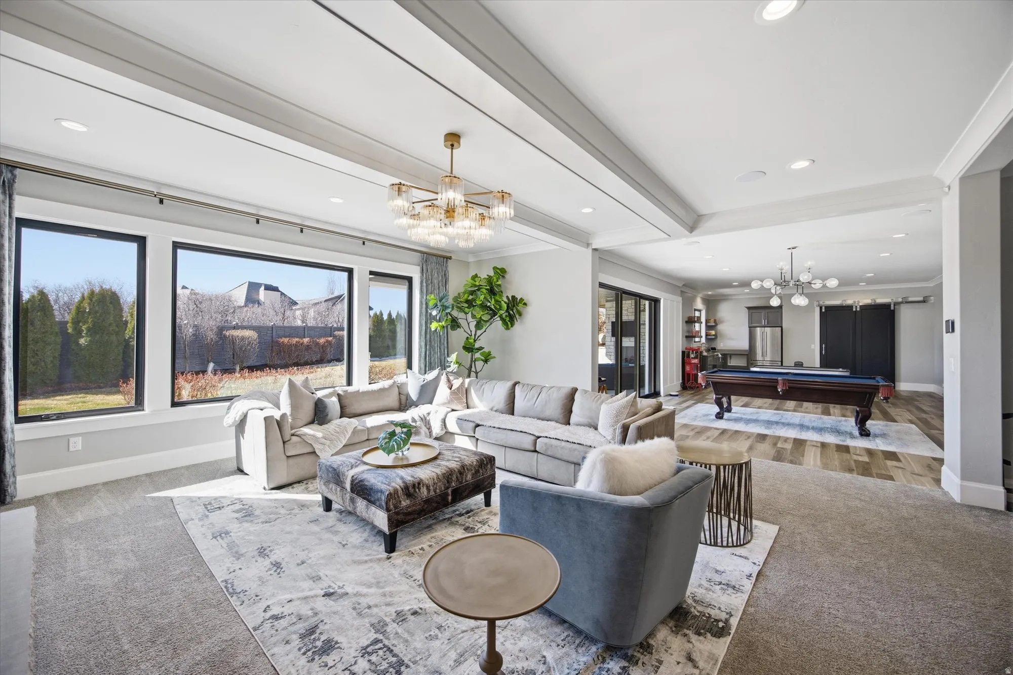 Carpeted living area featuring billiards, suspended lighting, beam ceiling, and crown molding