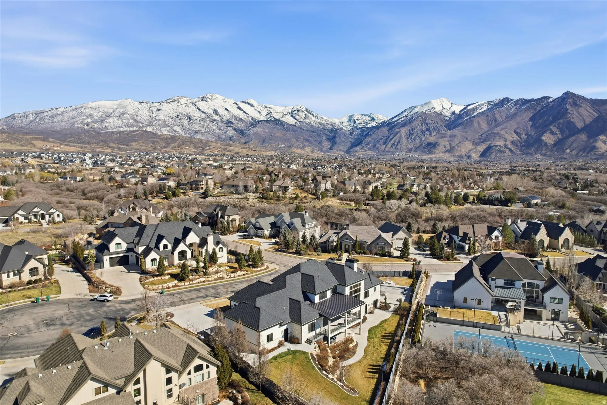 Aerial view of residential area featuring a mountainous background